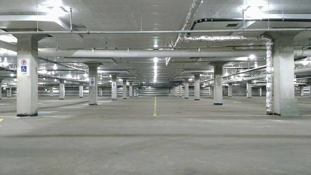 Parking garage that could be built with enhanced materials, designed to repair its own cracks and ensure long-lasting structural integrity without frequent maintenance.